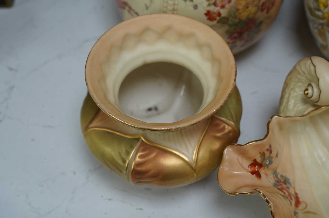 Two Worcester blush ivory biscuit jars and covers, numbers 1412 and 1796, a shell dish, number 971 and a vase, number 1877, tallest 17cm. Condition - mostly good, some wear to gilding